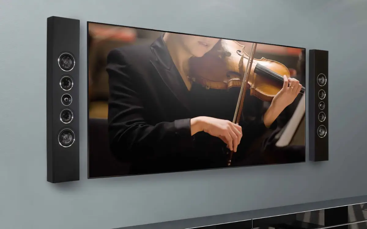 PSB PWM1 slim on-wall speakers mounted beside a television